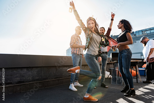 Carefree girl enjoying party on rooftop terrace