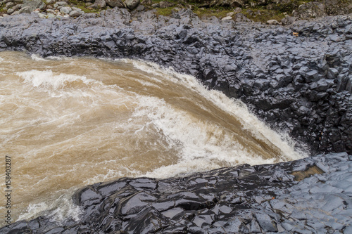 River entering Pailon del Diablo (Devil's Cauldron) waterfall near Banos town, Ecuador