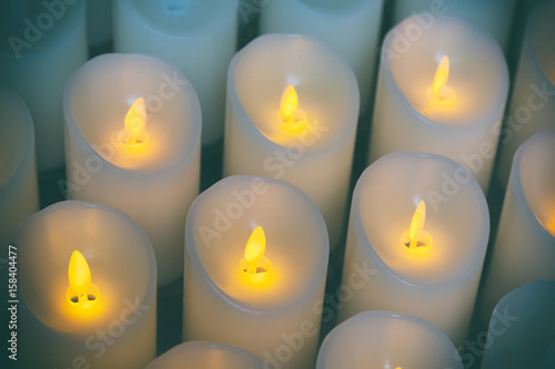 Candles light background of candles group In church