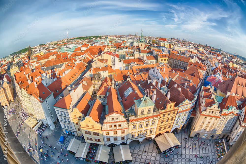 Obraz premium Houses with traditional red roofs in Prague Old Town Square in the Czech Republic. Fish-eye lens