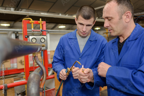 Workers lighting gas torch