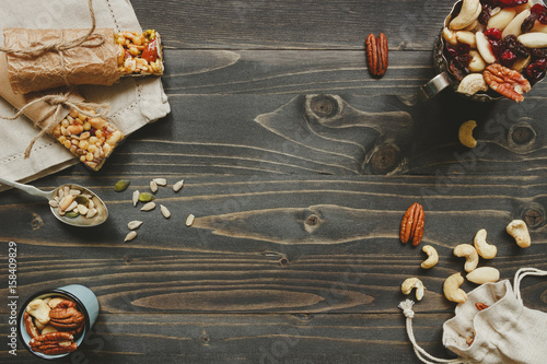 Nuts background. Healthy bars with nuts, seeds and dried fruits on the wooden table, with copy space