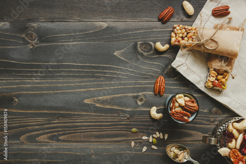 Nuts background. Healthy bars with nuts, seeds and dried fruits on the wooden table, with copy space