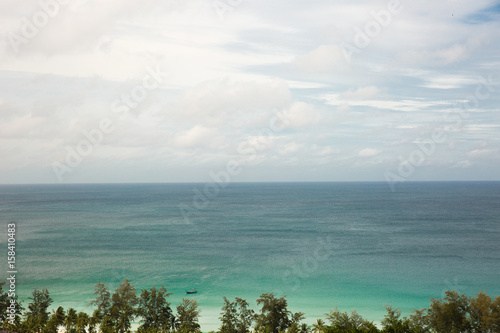 Sea view from tropical beach with sunny sky. Summer paradise beach of Phuket island. Tropical shore.Tropical sea in Puhket.Exotic summer beach with clouds on horizon.Ocean beach relax, outdoor travel