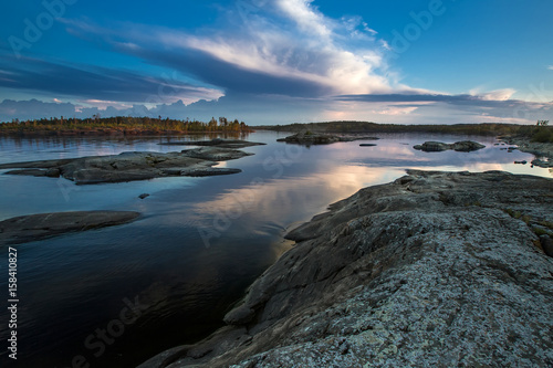 Evening. The stone shore. Wild nature. Evening sunset. Karelia. Ladoga lake.