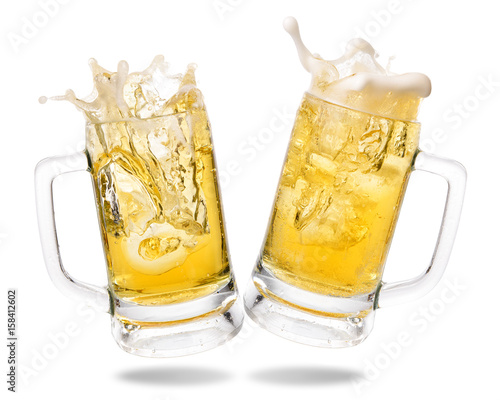Cheers cold beer with splashing out of glasses on white background.