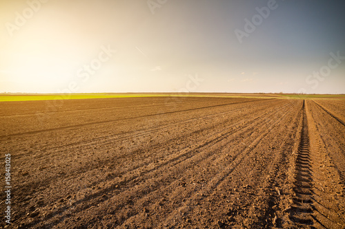 Agricultural landscape  arable crop field. Arable land is the land under temporary agricultural crops capable of being ploughed and used to grow crops.