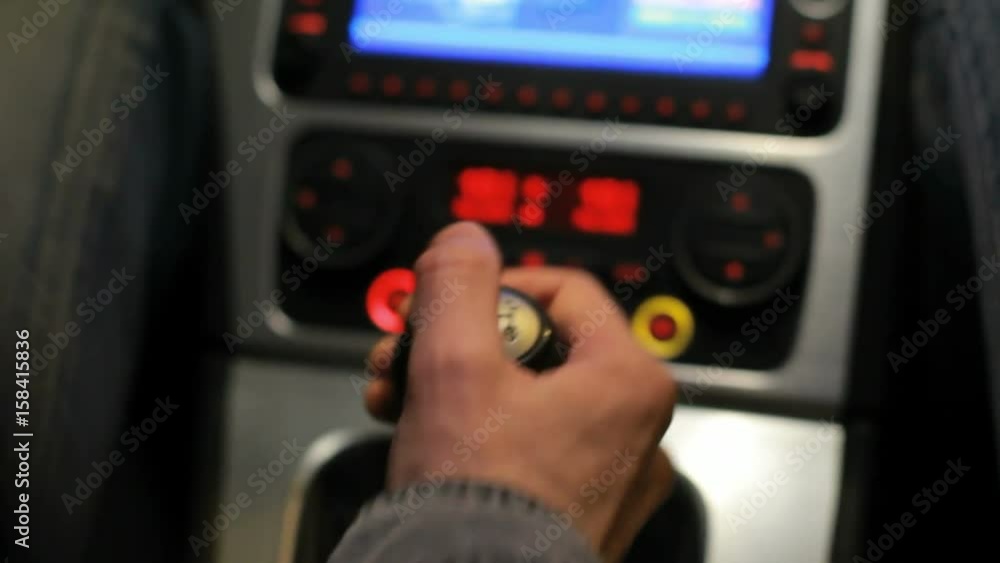 Man's hand switches manual transmission in car. Digital dashboard in car. Touchscreen control panel in auto. Close up of gear shift in auto. Car driver change gear. Gear shift knob Man's hand switches manual transmission in car. Digital dashboard in car. Touchscreen control panel in auto. Close up of gear shift in auto. Car driver change gear. Gear shift knob
