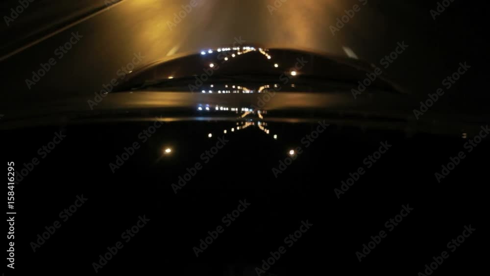 Video „Light reflections on car glass and car hood at night. Roof and hood of moving auto in