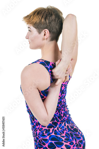 Healthy lifestyle, sport. Young girl kneads hands and shoulders, on a white background. Horizontal frame photo