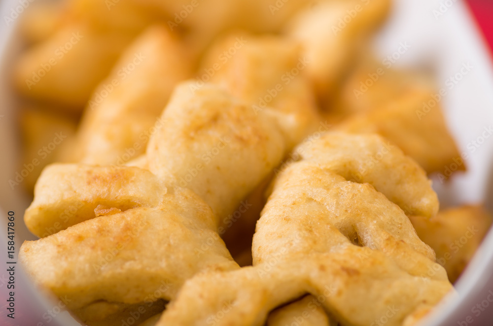 Closeup of delicious ecuadorian pristinos, piled up fresh from the fryer, traditional andean pastry suitable for coffee meetings