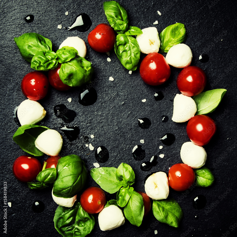 Caprese salad with mini mozzarella, green basil, cherry tomatoes
