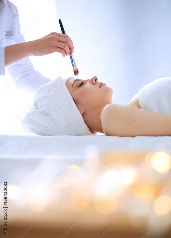 Young woman lying on a massage table,relaxing with eyes closed Young woman lying on a massage table,relaxing with eyes closed