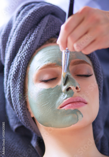 Beautiful woman having mask , lying on spa photo