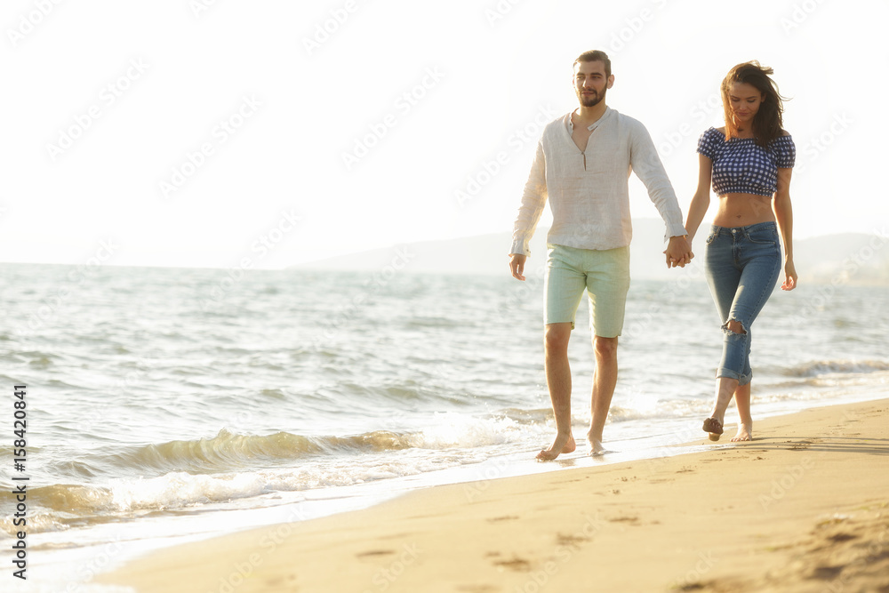 happy couple waling on the beach and having fun happy couple waling on the beach and having fun