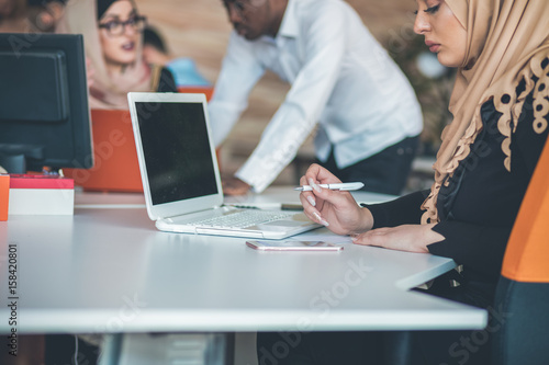 Young Arabic business woman wearing hijab,working in her startup office.