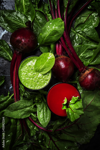 Detox smoothies from raw beets and spinach, dark food background, top view