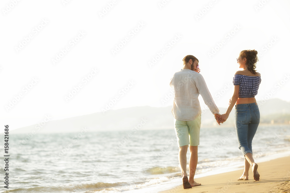 happy couple waling on the beach and having fun happy couple waling on the beach and having fun