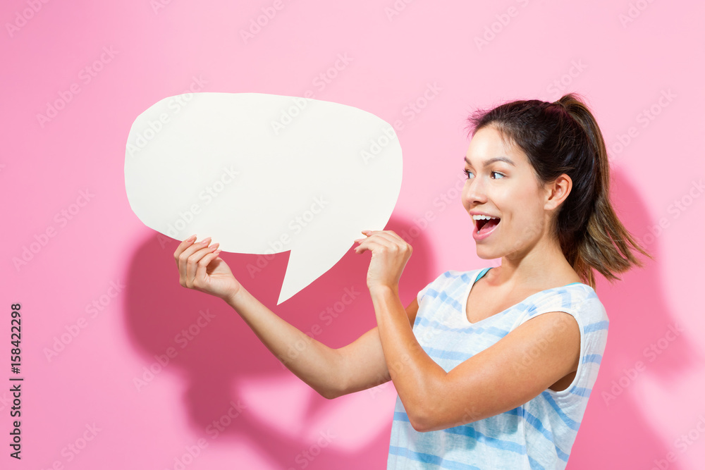 Young woman holding a speech bubble Young woman holding a speech bubble