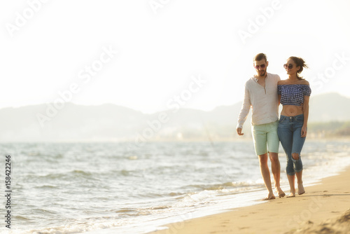 happy couple waling on the beach and having fun © FS-Stock