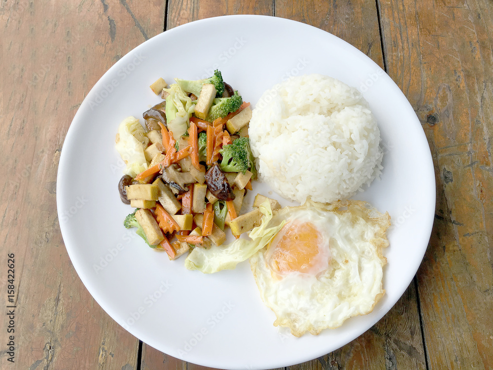 Stir Fried Tofu in Chinese Style, Deep Fried Tofu with Gravy Sauce ,Stir fried tofu with mixed vegetables and fried egg in white plate on white background. Vegetarian Food, healthy food. Stir Fried Tofu in Chinese Style, Deep Fried Tofu with Gravy Sauce ,Stir fried tofu with mixed vegetables and fried egg in white plate on white background. Vegetarian Food, healthy food.