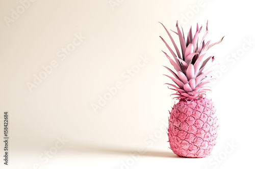 Pink painted pineapple on a white background
