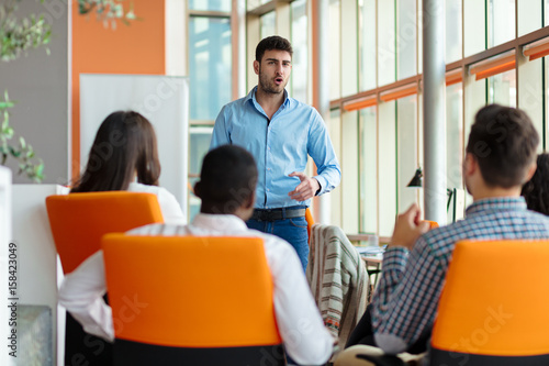 business, startup, presentation, strategy and people concept - man making presentation to creative team at office