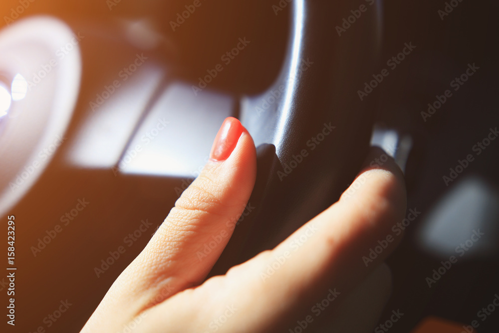 Woman hand on  steering wheel
