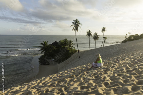 A woman at Sunrise in Genipabu, Natal, RN, Brazil photo