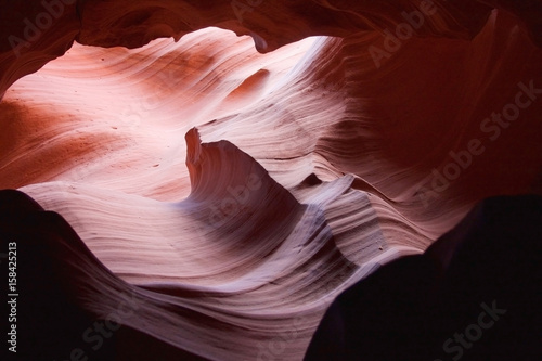 Nature red sandstone textured background. Swirls of old red sandstone wall abstract pattern in Lower Antelope Canyon, Page, Arizona, USA.