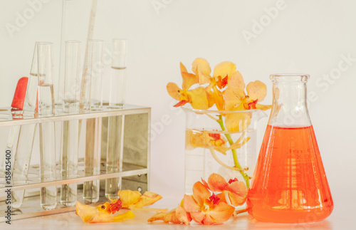 Orchid flowers in chemical laboratory for purfume analysis photo