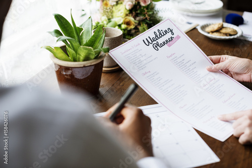 Hands Holding Wedding Planner Checklist Information Preparation