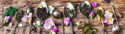 Tea spoons with tea leaves