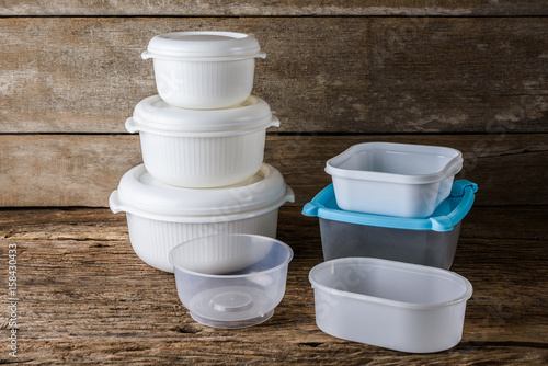 Empty containers for food on wooden background