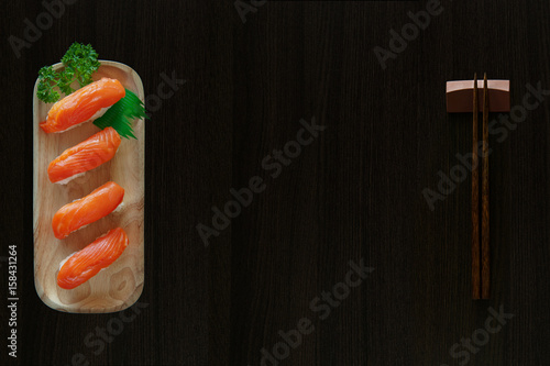 sushi with salmon, Sushi menu. Japanese food, sashimi sushi set with chopsticks and soy  on black background