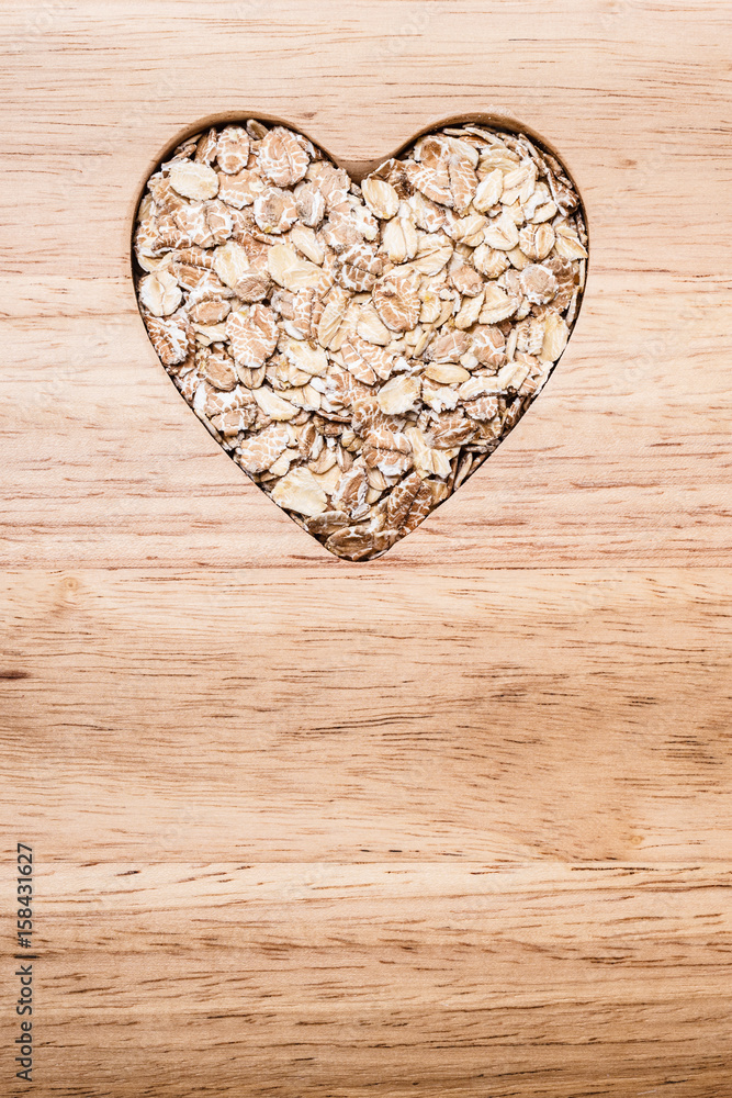 Oat cereal heart shaped on wooden surface. Oat cereal heart shaped on wooden surface.