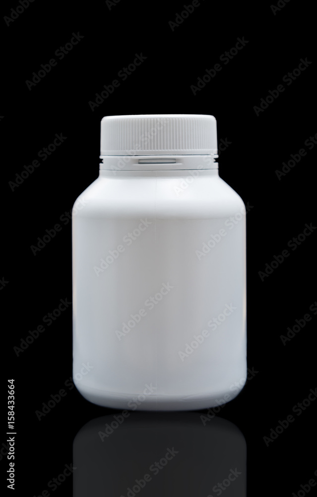 Vitamin plastic pill bottle medicine isolated on black Vitamin plastic pill bottle medicine isolated on black