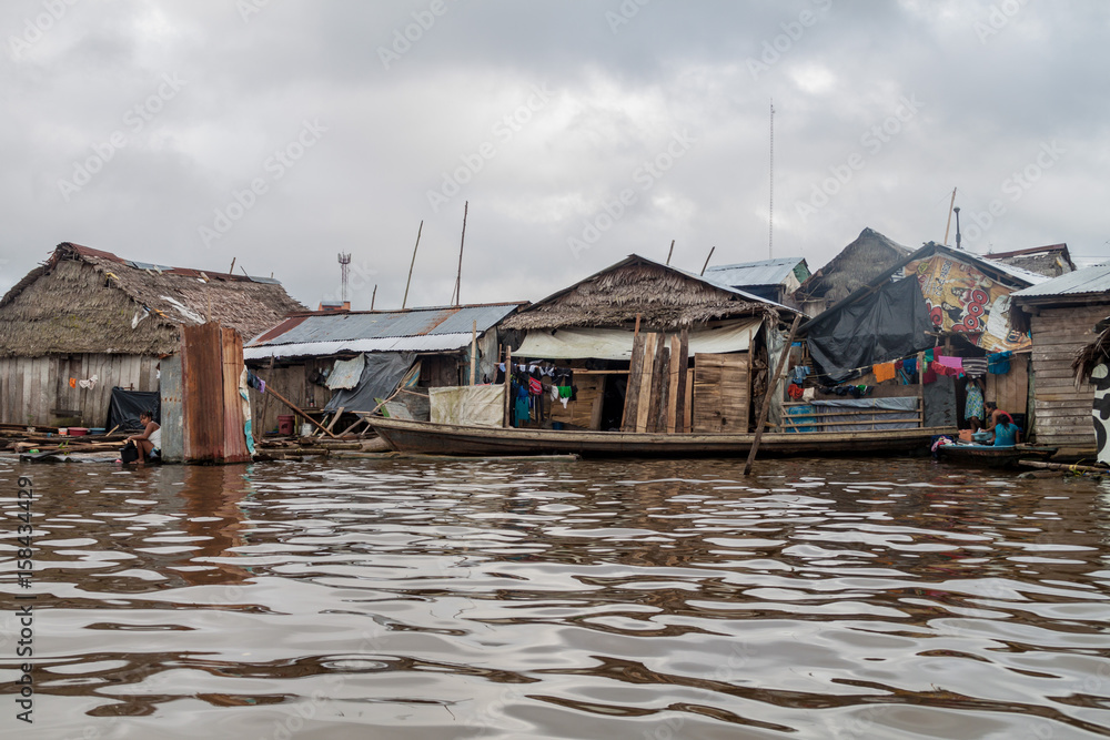 IQUITOS, PERU - JULY 18, 2015: View of partially floating shantytown in Belen neigbohood of Iquitos, Peru. IQUITOS, PERU - JULY 18, 2015: View of partially floating shantytown in Belen neigbohood of Iquitos, Peru.