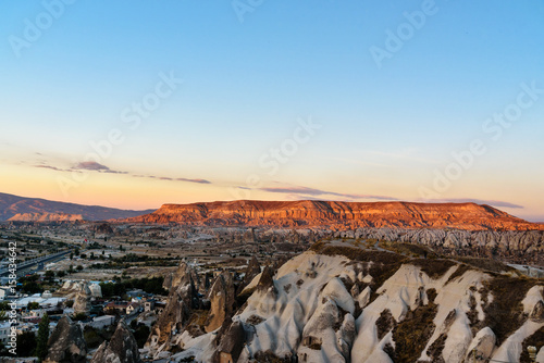 View of cave houses and rock formations at sunset. Goreme. Cappadocia. Turkey