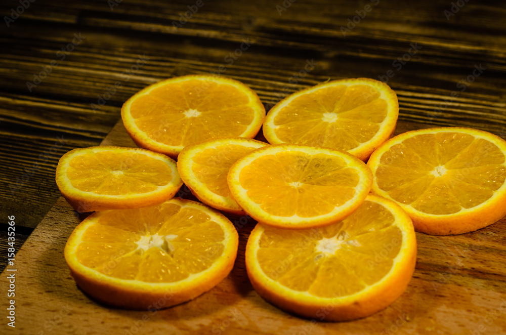 Orange slices on wooden table Orange slices on wooden table