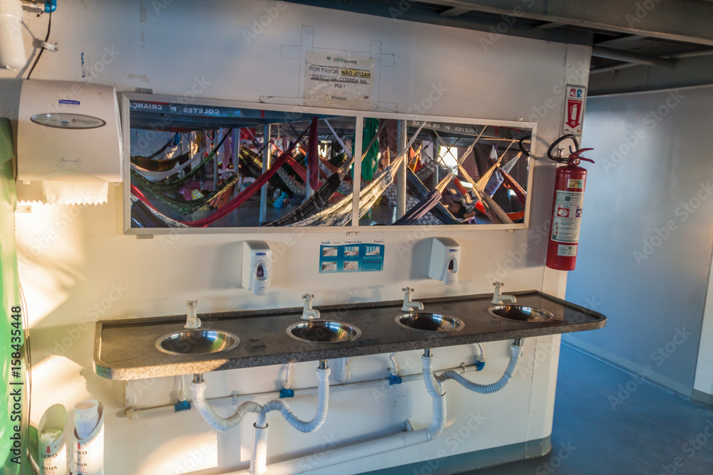 AMAZON, BRAZIL - JUNE 23, 2015: Sinks at the washroom at the boat Diamante which plies river Amazon between Tabatinga and Manaus, Brazil. AMAZON, BRAZIL - JUNE 23, 2015: Sinks at the washroom at the boat Diamante which plies river Amazon between Tabatinga and Manaus, Brazil.