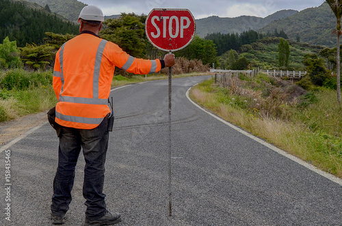 Man holding STOP sign