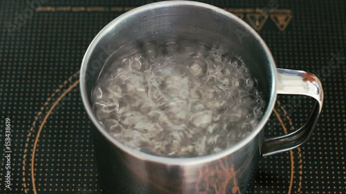 Pot full of boiling water on the induction cooker