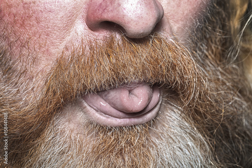 ginger bearded man showing tongue