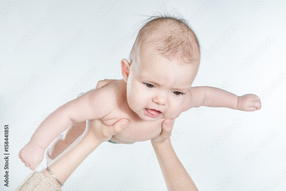 Female hands holding a baby on a white background. Isolated Female hands holding a baby on a white background. Isolated