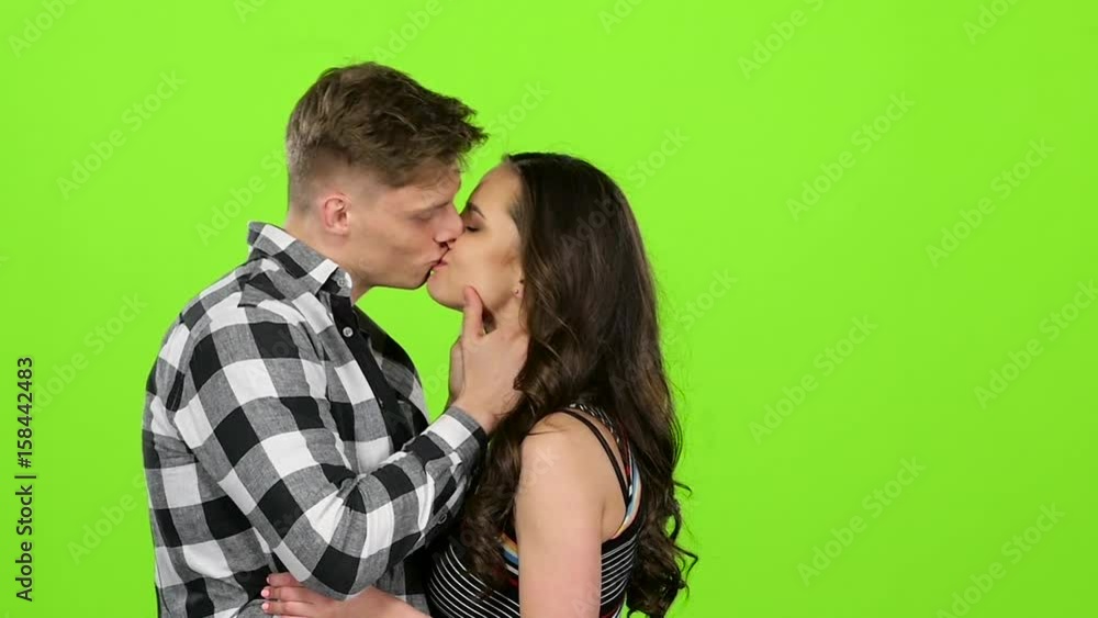 Loving couple look at each other and begin to kiss. Green screen. Slow motion Loving couple look at each other and begin to kiss. Green screen. Slow motion