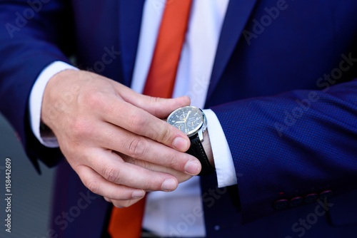 Businessman looks at his watch.