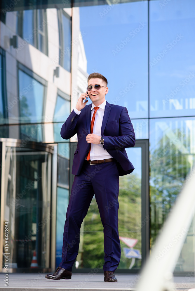 Successful businessman talking on the phone and smiling. Successful businessman talking on the phone and smiling.