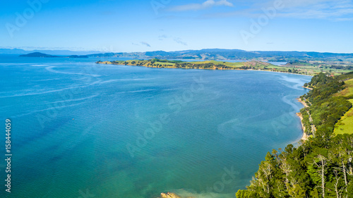 Fototapeta Naklejka Na Ścianę i Meble -  Aerial view on beautiful harbour with sunny beach and surrounding hillside, New Zealand