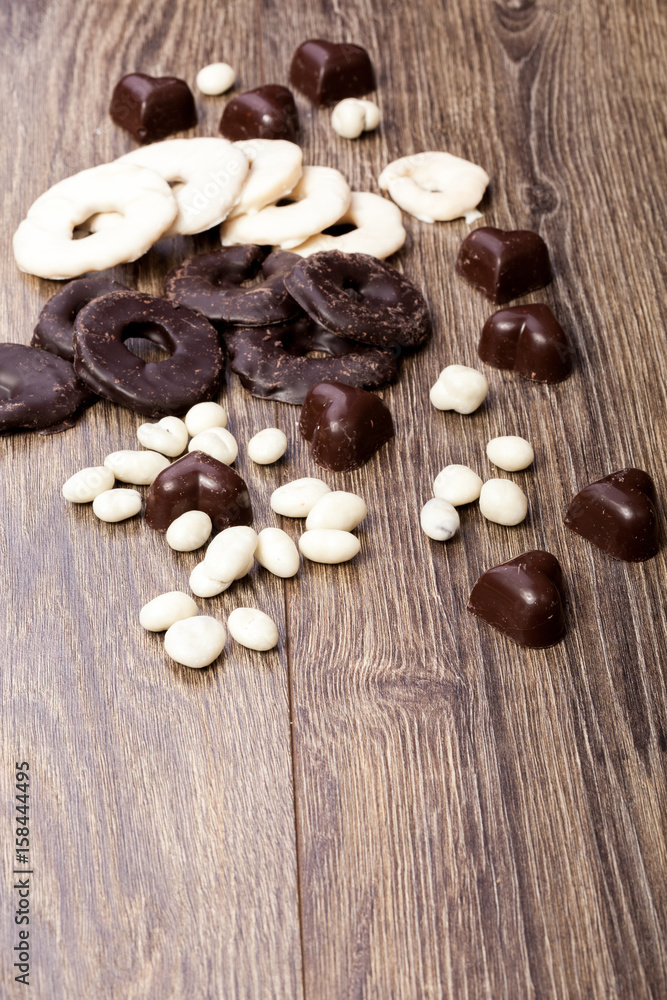 Healthy type candy from dried fruit in chocolate. Shot on wood type background
